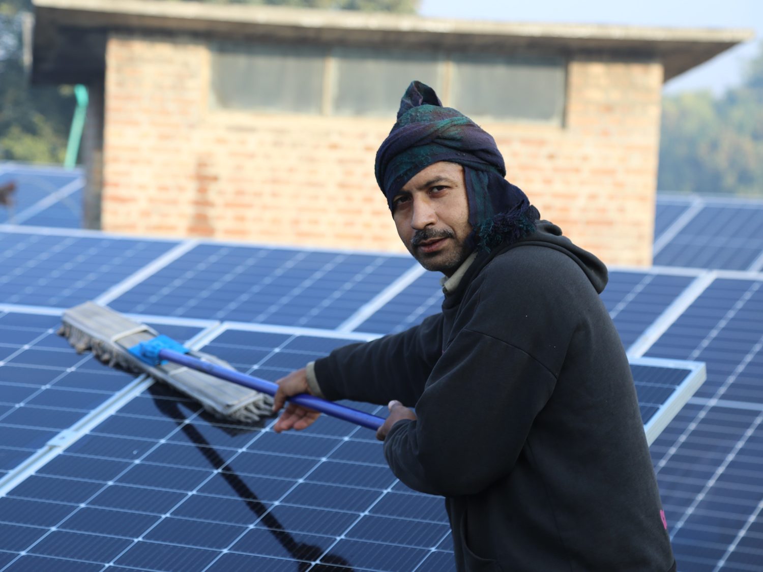S3 technician cleaning a rooftop solar array