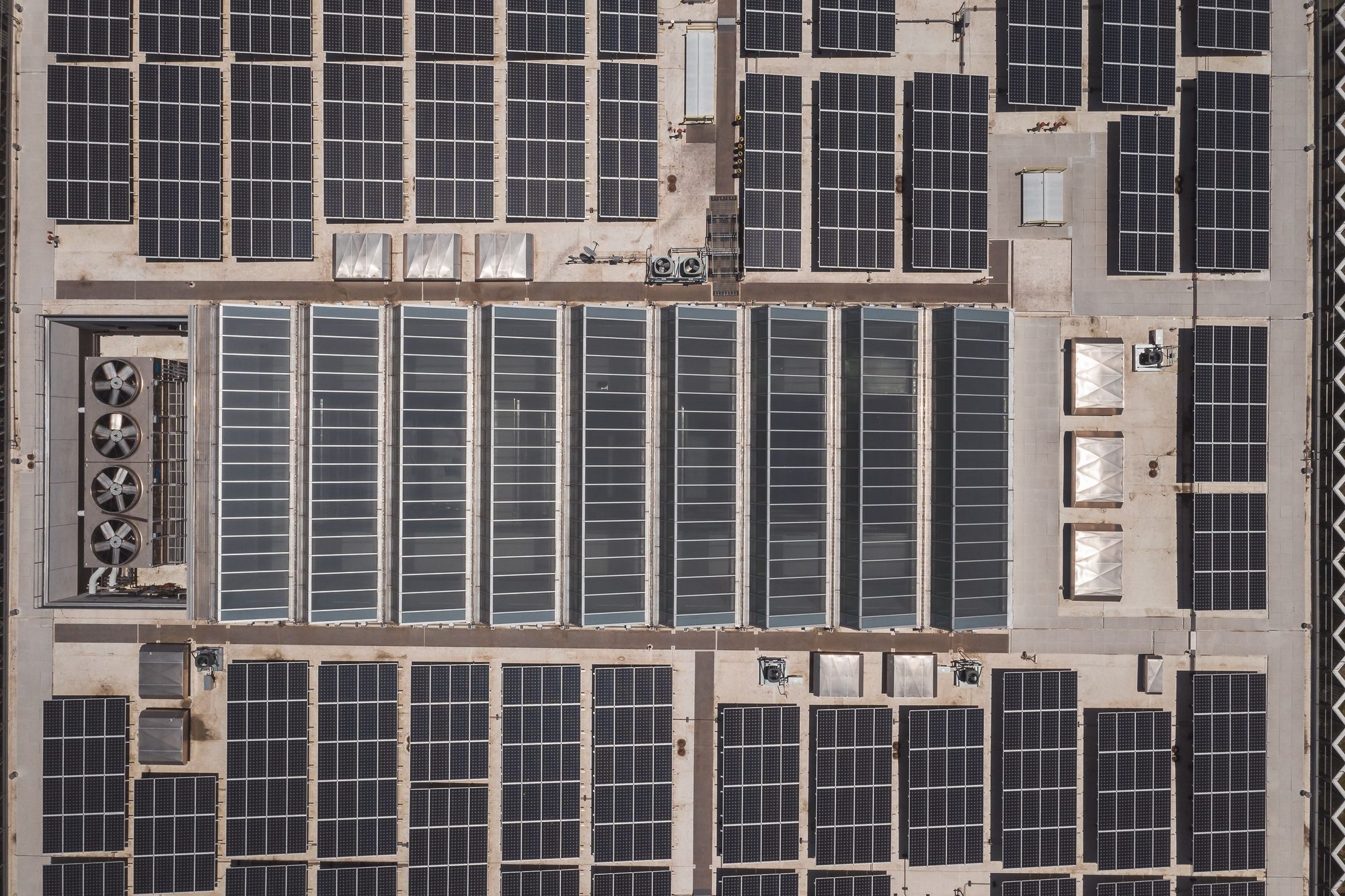 Top-down aerial of a commercial roof densely packed with solar panels