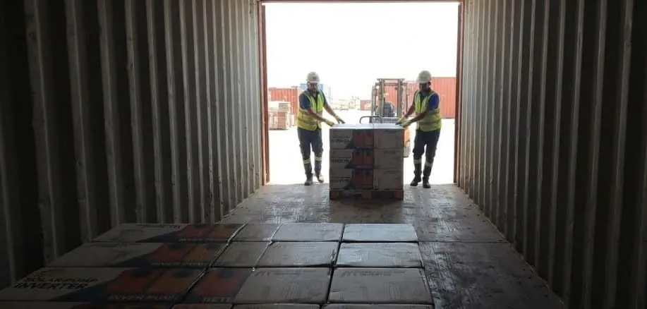 S3 Solar inverters being unloaded from a shipping container