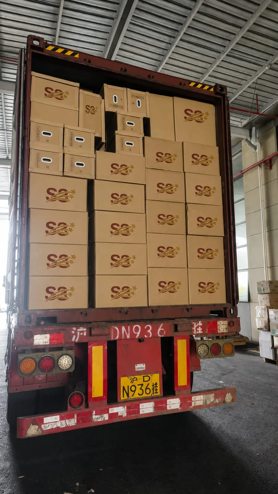 A shipping container packed to the roof with S3-branded cartons
