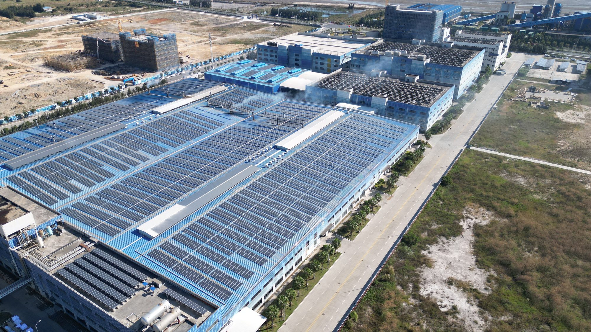 Aerial view of an industrial roof fully covered in solar panels