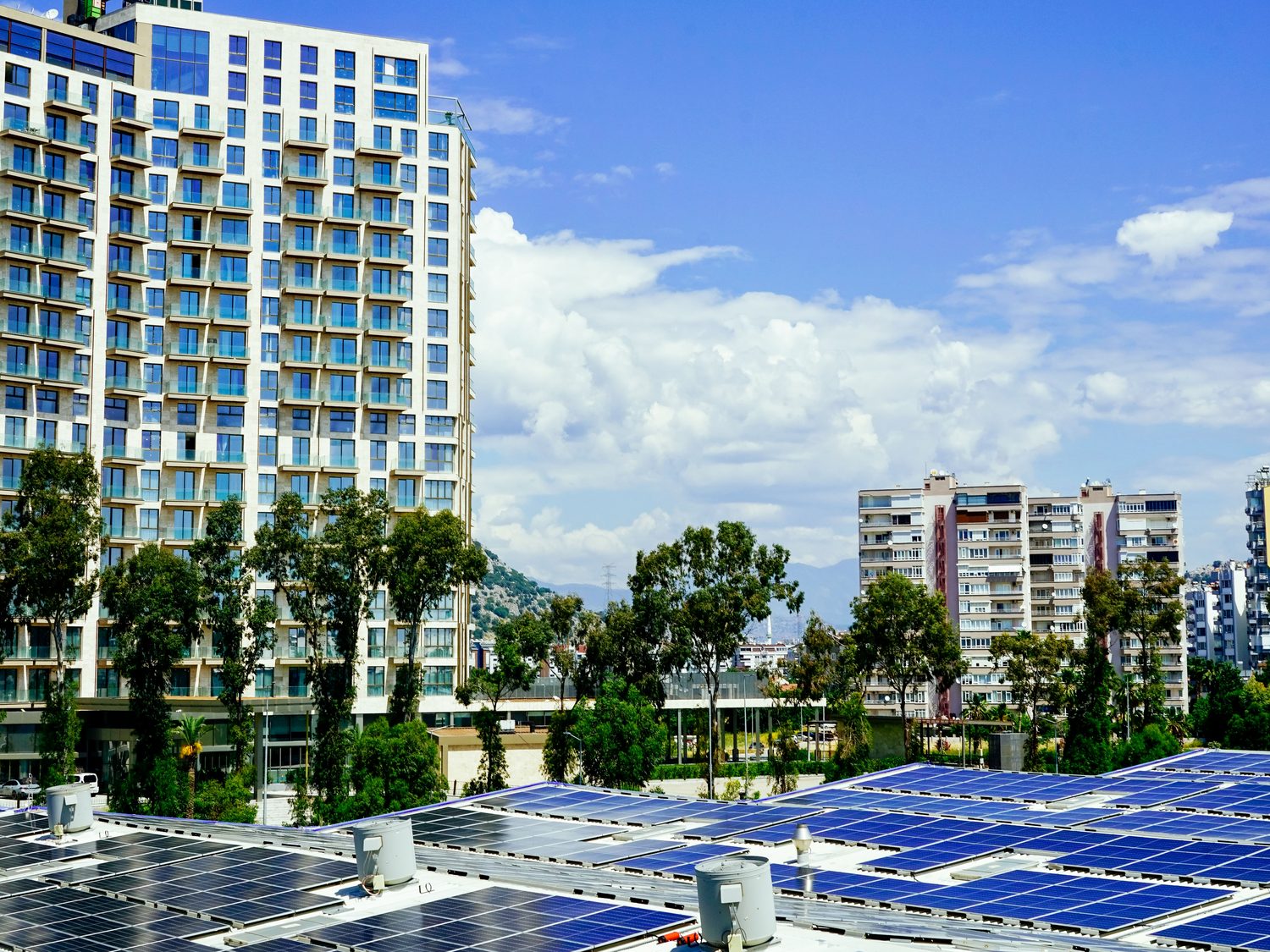 Rooftop solar array with residential apartment towers behind