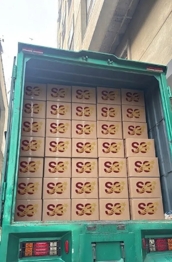 A truck bed stacked with S3 Solar-branded inverter boxes for a bulk order
